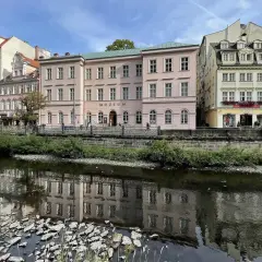 Nad rzeką w Karlowych Warach odbijają się w wodzie zabytkowe kamienice i budynek muzeum.