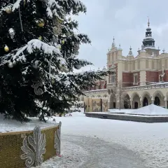 Świąteczna choinka i ośnieżone Sukiennice na Rynku Głównym. Kraków atrakcje zimą zachwycają.