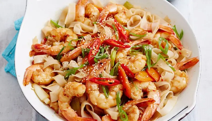 Pyszne danie z krewetkami, makaronem ryżowym, papryczką chili i sezamem.
